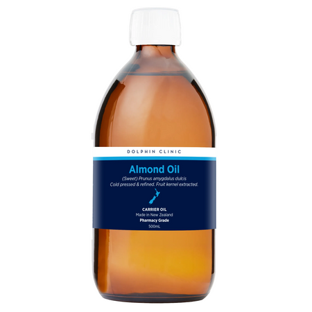 Bottle of almond oil with a blue label on a white background