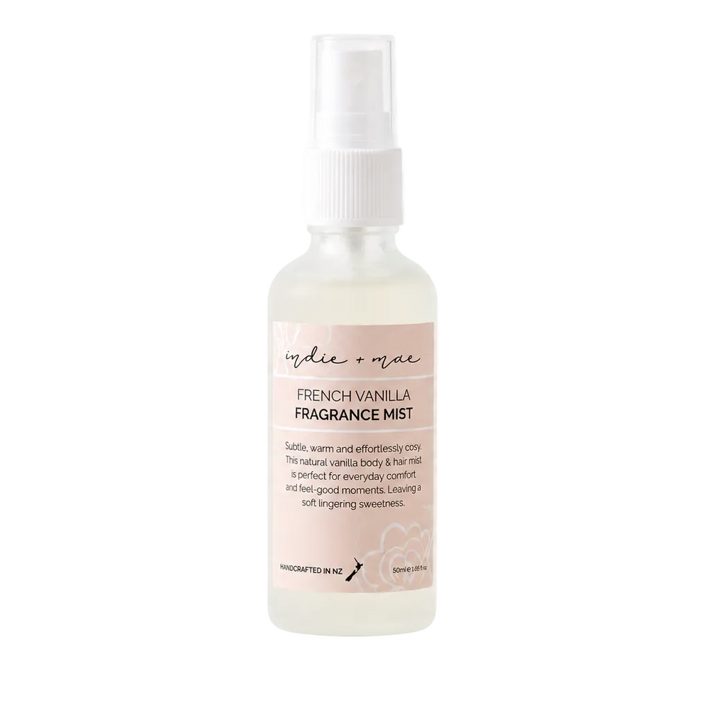 A bottle of 'nude + lace' French Vanilla Fragrance Mist on a white background with a faint gray grid pattern.
