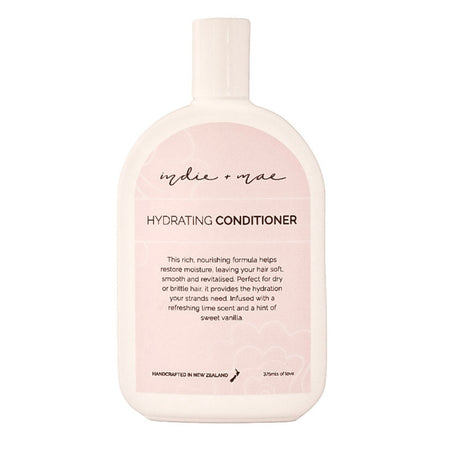 A bottle of Mudeu Mac Hydrating Conditioner, featuring a soft blush pink and white color scheme with black text, set against a plain white background.