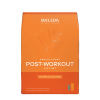 A bright orange bag of Weleda Natural Science Arnica Sport Post-Workout Gift Set, featuring white text and botanical line art, on a clean white background.