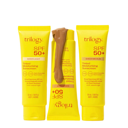 Three yellow tubes of Trilogy SPF 50+ sunscreen on a white background