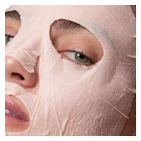 Close-up of a person wearing a pink face mask, focusing on the eye area.