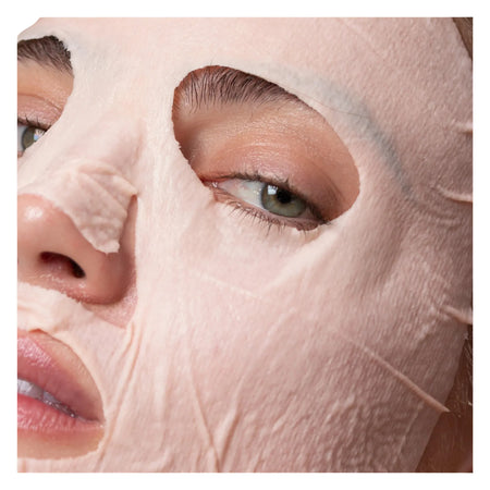 Close-up of a person wearing a pink face mask, focusing on the eye area.