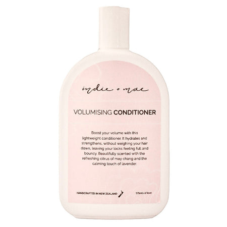 A bottle of 'indie or not' Volumising Conditioner, featuring a pale pink and white design with black text, centered on a solid white background.